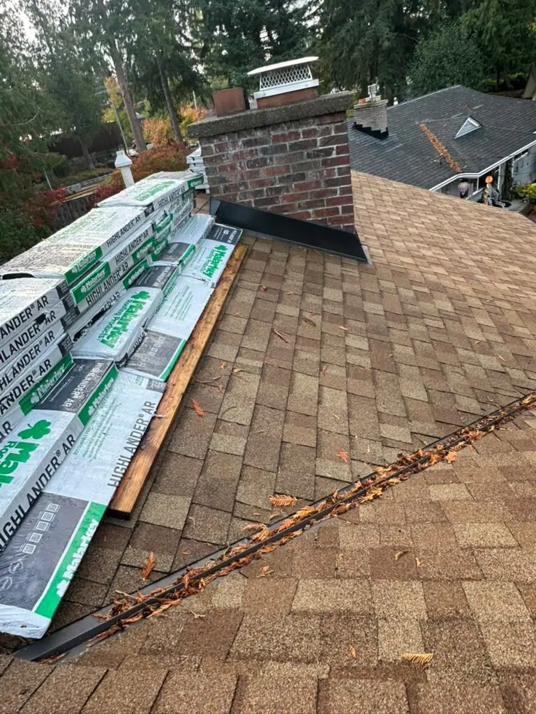 Shingle bundles staged next to the chimney