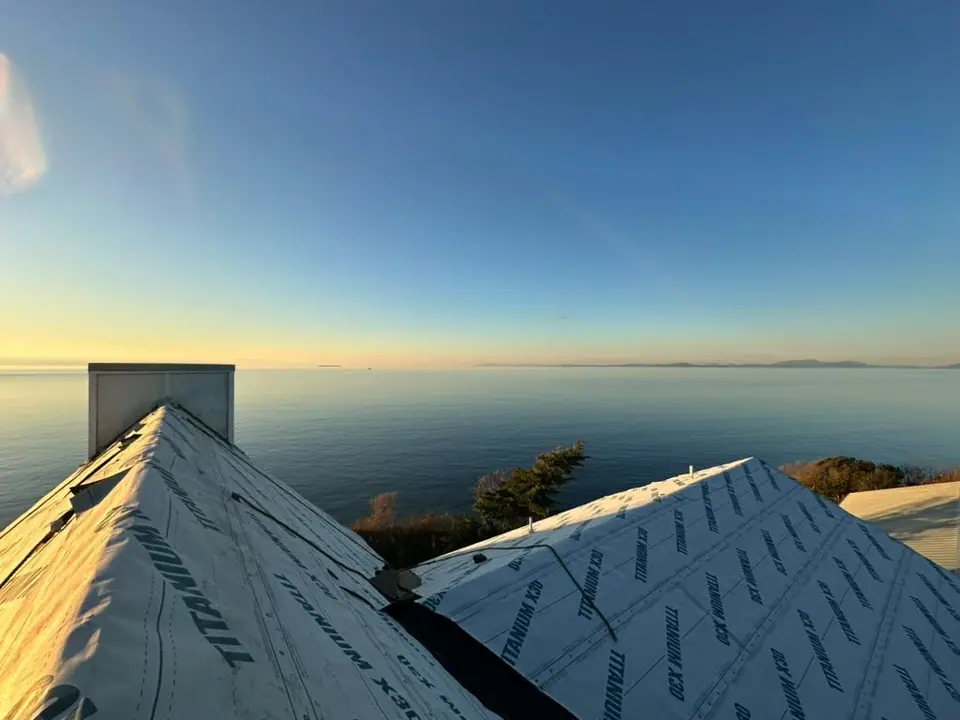 Synthetic underlayment on, ready for shingles, at sunset