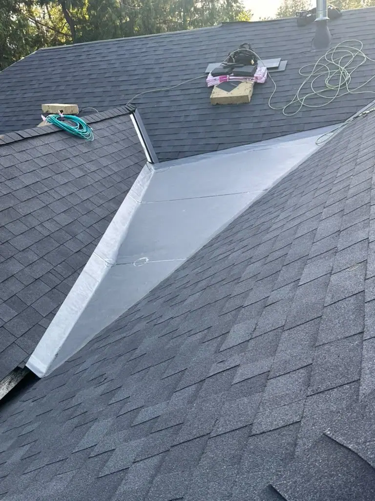 Metal valley between new shingles
