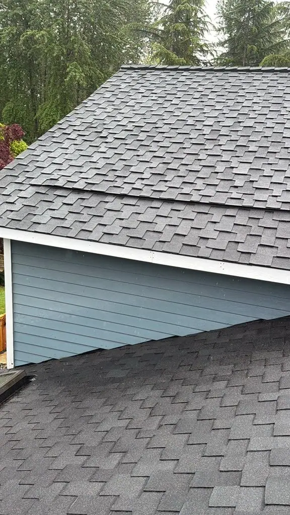 New shingles where two roofs meet a wall