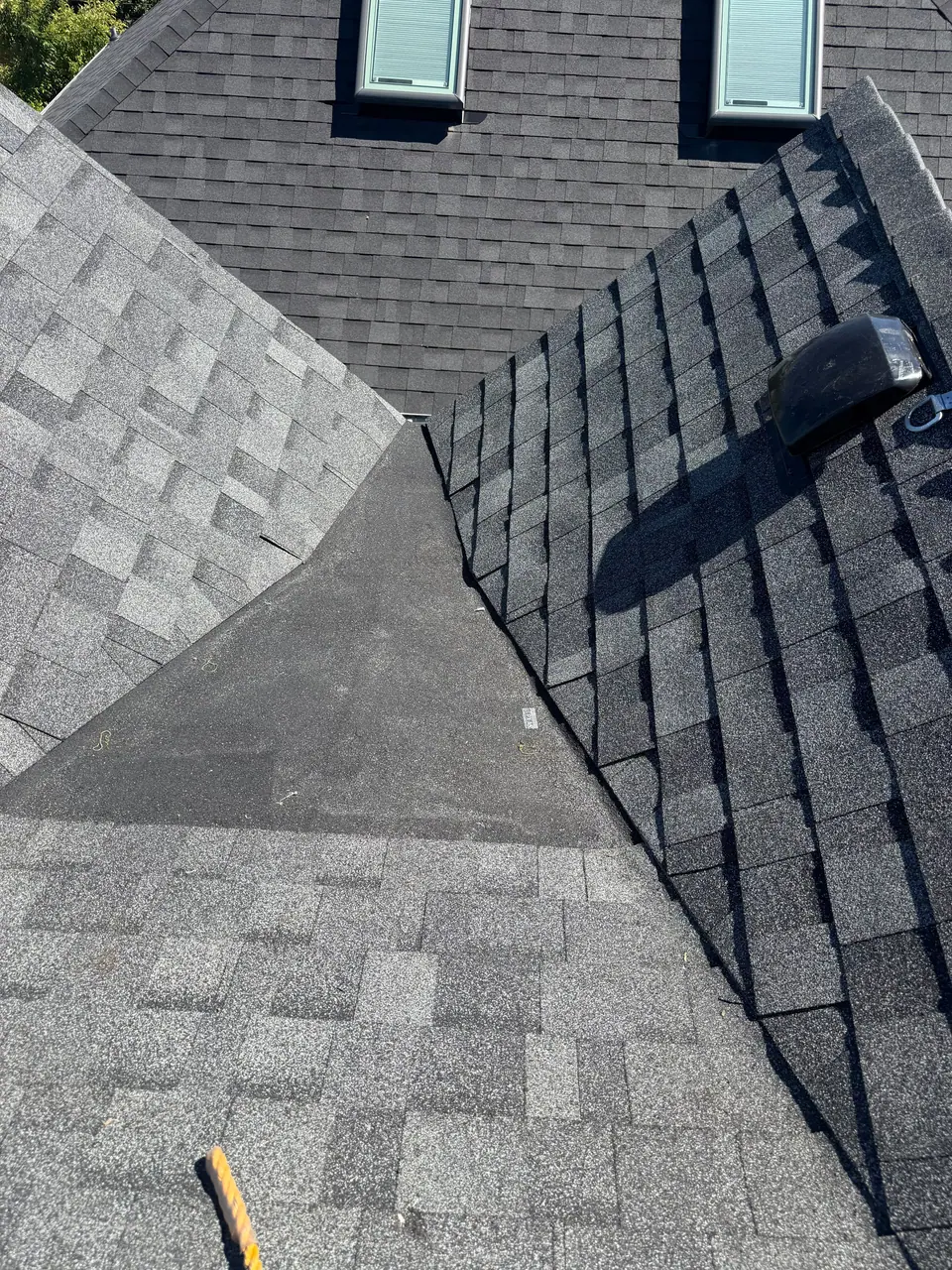 Old and new shingles meeting in a valley