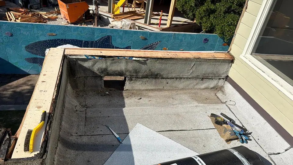 New wood and base layer at the parapet