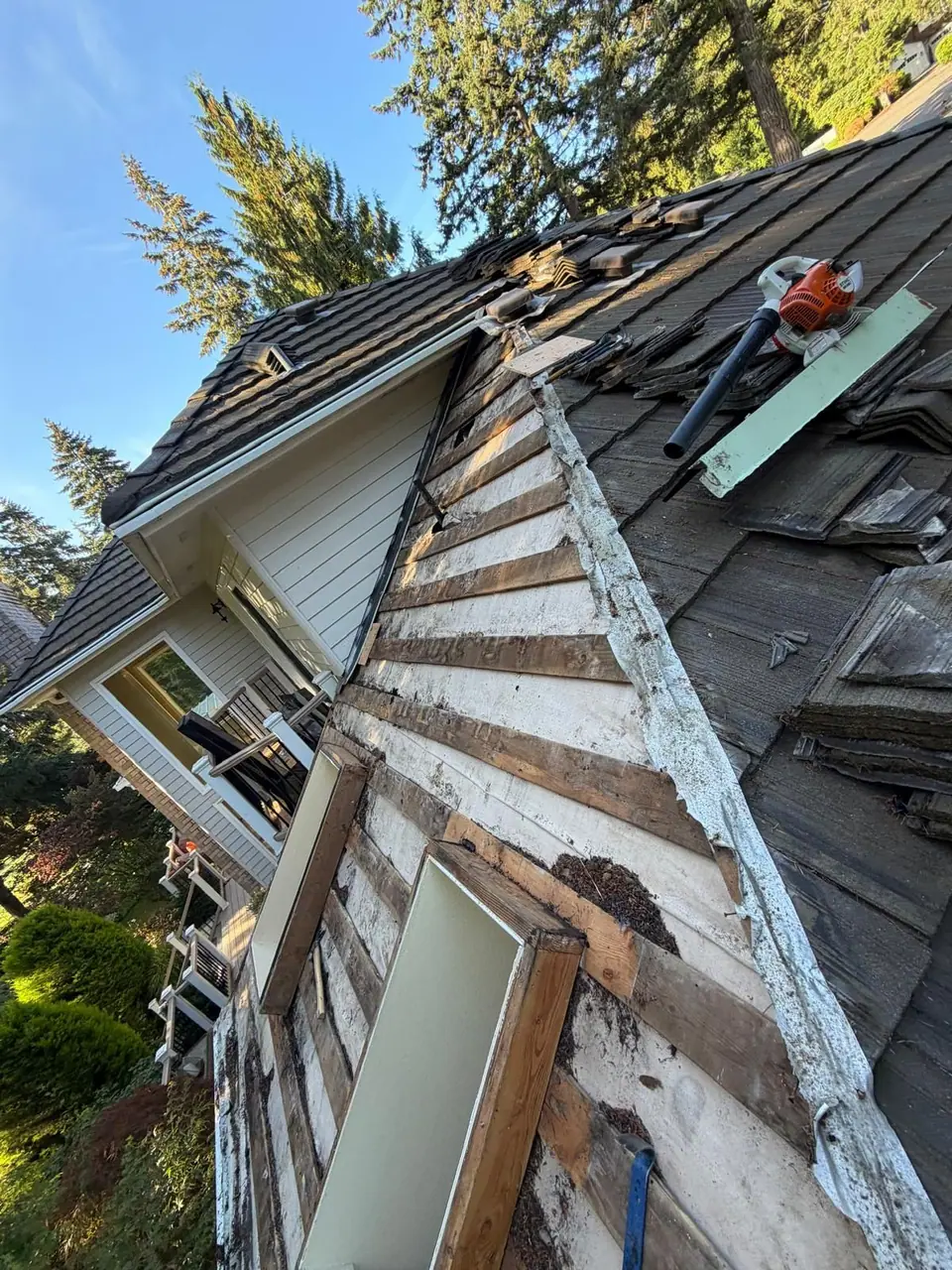 Old shakes off around a skylight
