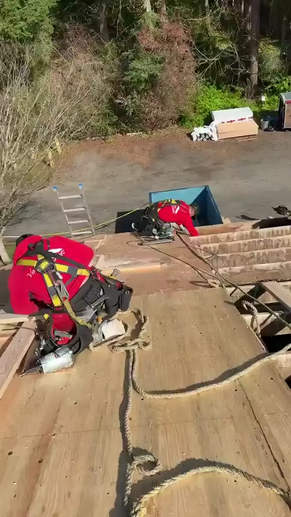 Crew re-decking over open rafters